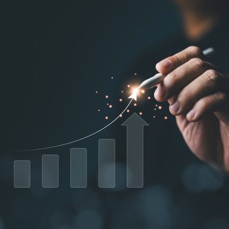 Strategic planner, Analyst, Investor, or Trader analyzing data to increase profits and company growth. Hand with many increasing bar graph charts for stock investments. Business strategy concept.